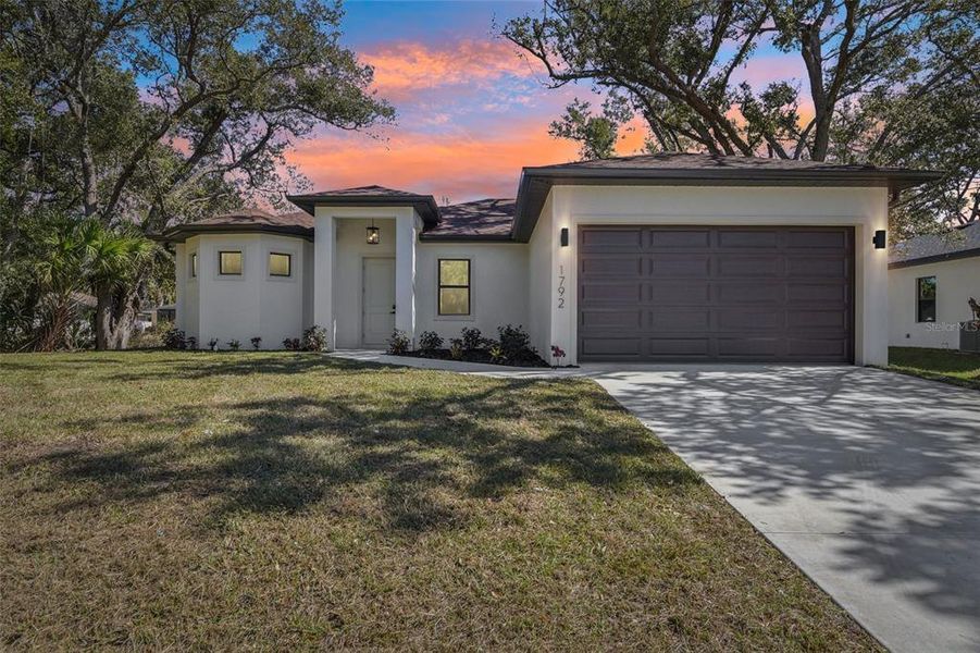 Front exterior of a new home in , North Port, FL, highlighting curb appeal (Image 29). Front exterior of a new home in , North Port, FL, highlighting curb appeal (Image 29).