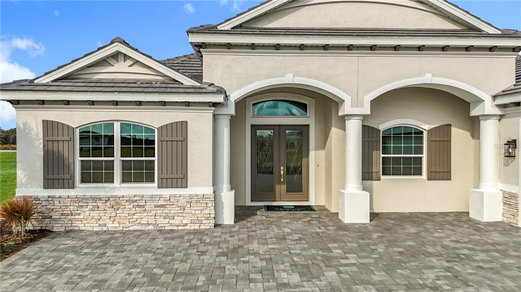 Front exterior of a new home in Hampton Lakes, Sarasota, FL, highlighting curb appeal (Image 28). Front exterior of a new home in Hampton Lakes, Sarasota, FL, highlighting curb appeal (Image 28).
