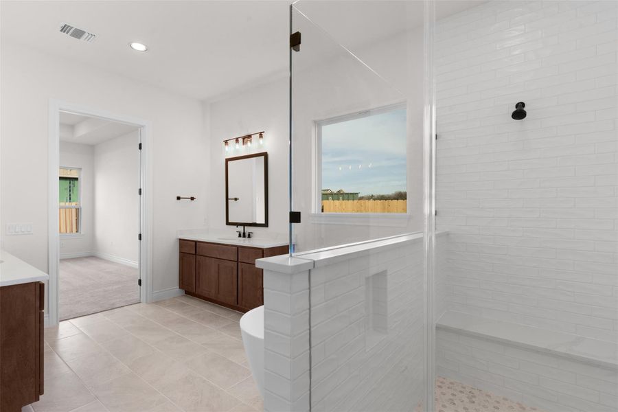 Full bathroom with vanity, a shower stall, a freestanding tub, light tile patterned floors, and recessed lighting