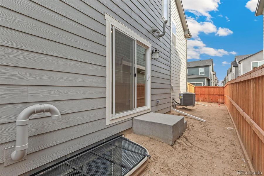 Exterior details and patio area of a home in Sky Ranch Villas, Watkins (Image 3).