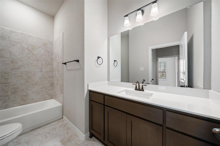 Bathroom featuring vanity and shower / tub combination Bathroom featuring vanity and shower / tub combination