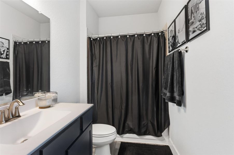 Modern and sleek second bathroom with stylish fixtures and ample storage. Modern and sleek second bathroom with stylish fixtures and ample storage.