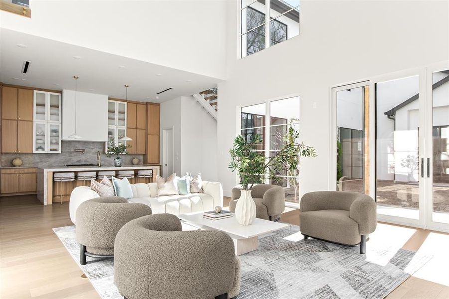 Vaulted living space featuring wood-finish flooring and extensive windows