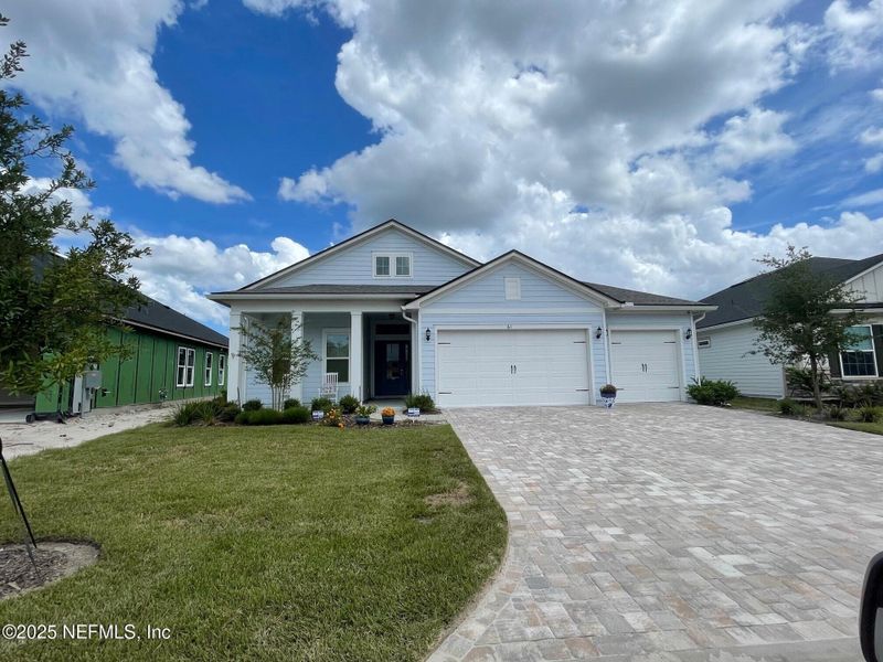 Front exterior of a new home in Amelia National Country Club, Fernandina Beach, FL, highlighting curb appeal (Image 14). Front exterior of a new home in Amelia National Country Club, Fernandina Beach, FL, highlighting curb appeal (Image 14).