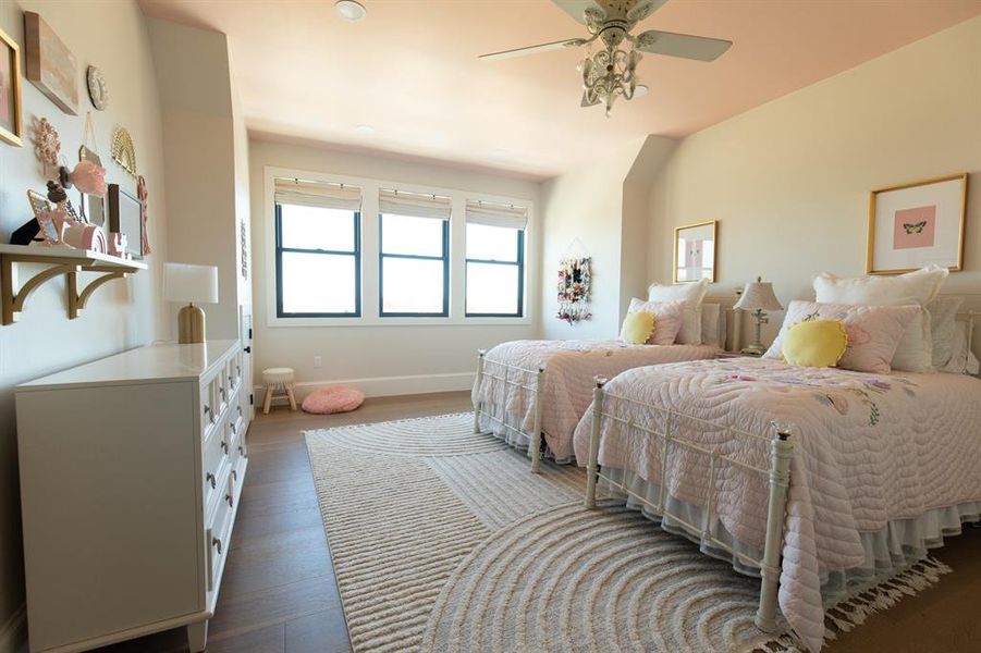 Bedroom with dark wood-type flooring and a ceiling fan