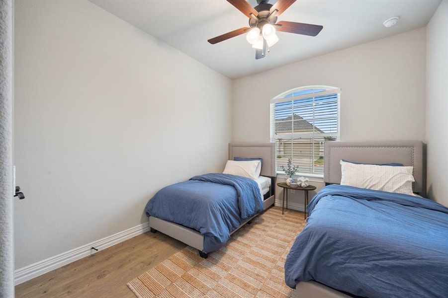Bedroom featuring wood finished floors and ceiling fan