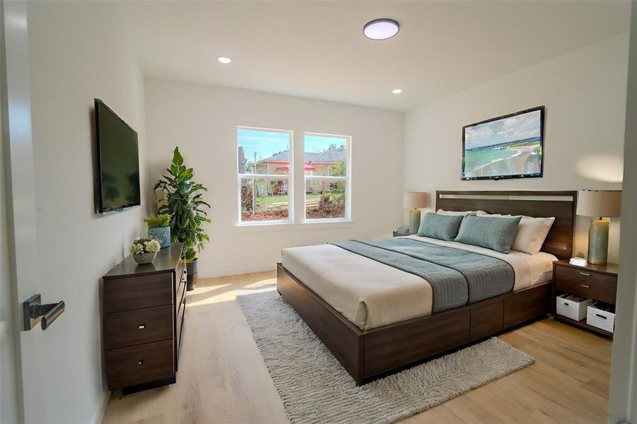 Bedroom with light hardwood / wood-style flooring