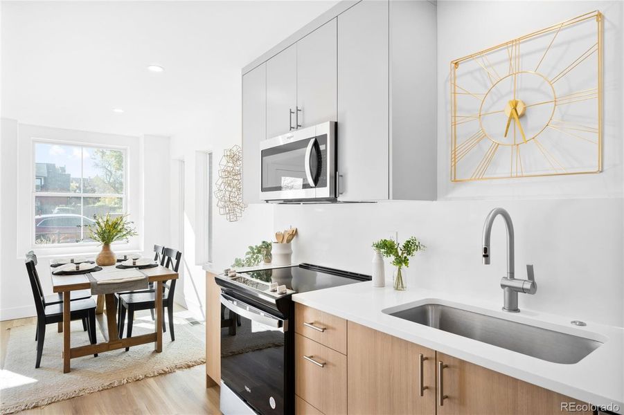 Modern cabinetry and sleek appliances anchor this bright kitchen with timeless contemporary style.