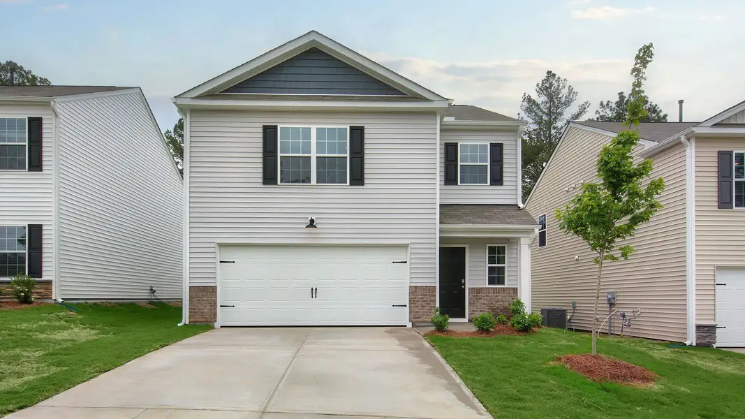 Front exterior of a new home in Laurel Oaks, Sanford, NC, highlighting curb appeal (Image 2). Front exterior of a new home in Laurel Oaks, Sanford, NC, highlighting curb appeal (Image 2).