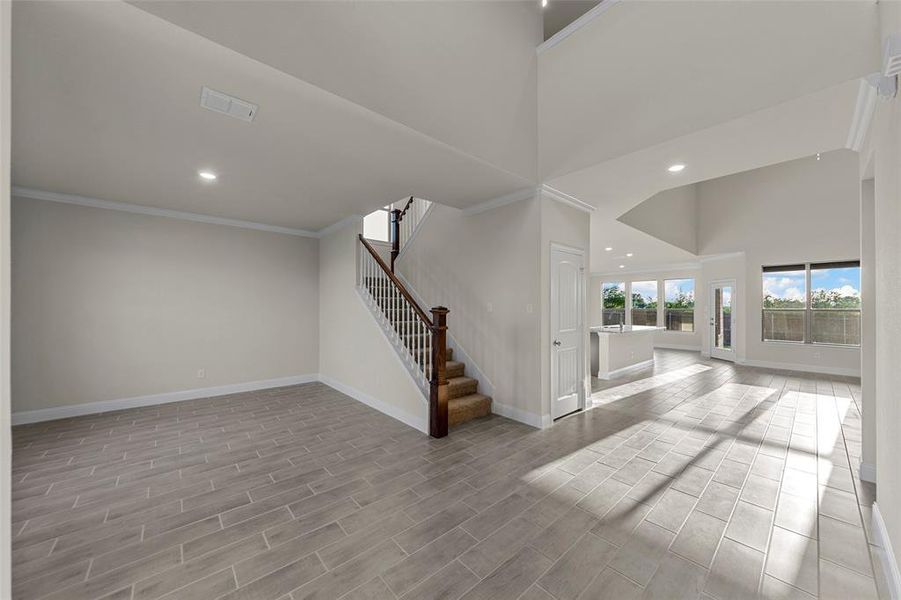 Below grade area featuring recessed lighting, stairway, wood tiled floors, and ornamental molding Below grade area featuring recessed lighting, stairway, wood tiled floors, and ornamental molding