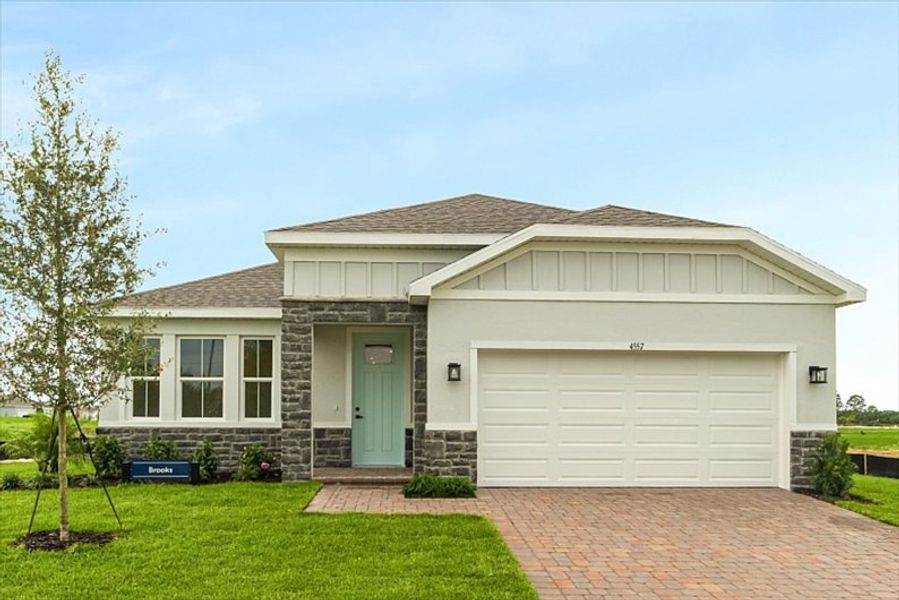 Front exterior of a new home in Lost Tree Preserve, Vero Beach, FL, highlighting curb appeal (Image 1).