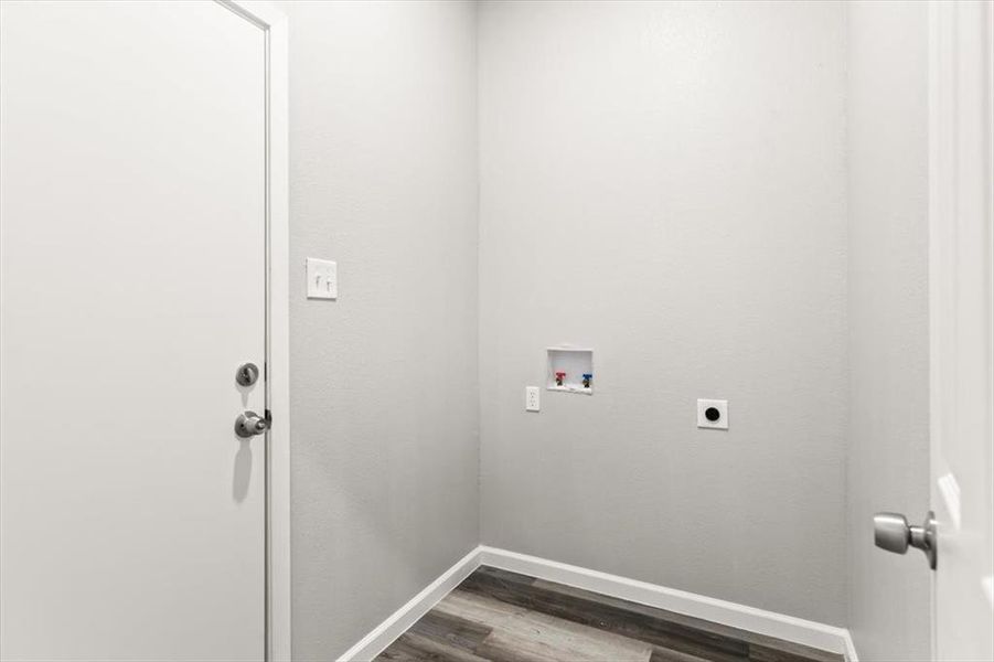 Washroom featuring hookup for an electric dryer, hookup for a washing machine, and hardwood / wood-style floors