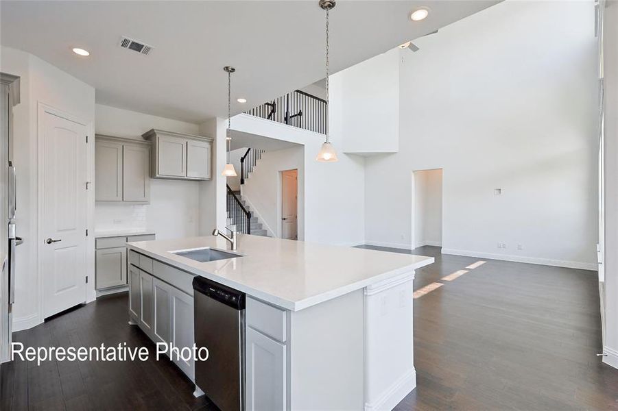 Kitchen featuring a center island with sink, dark hardwood / wood-style flooring, sink, and stainless steel dishwasher