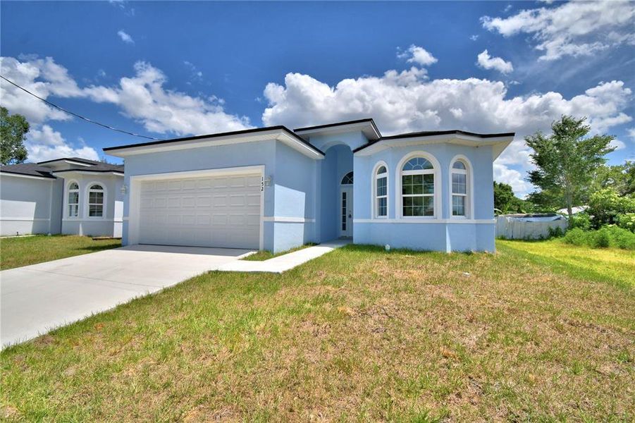 Front exterior of a new home in , Winter Haven, FL, highlighting curb appeal (Image 21).