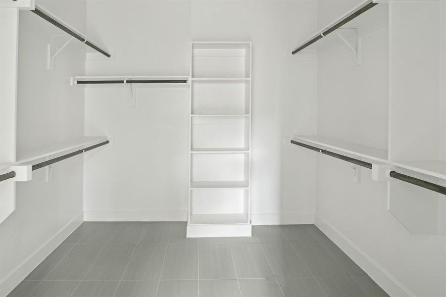 Spacious Primary closet with tile patterned flooring