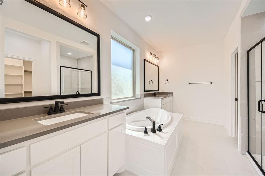 Bathroom featuring vanity, plus walk in shower, and tile patterned flooring