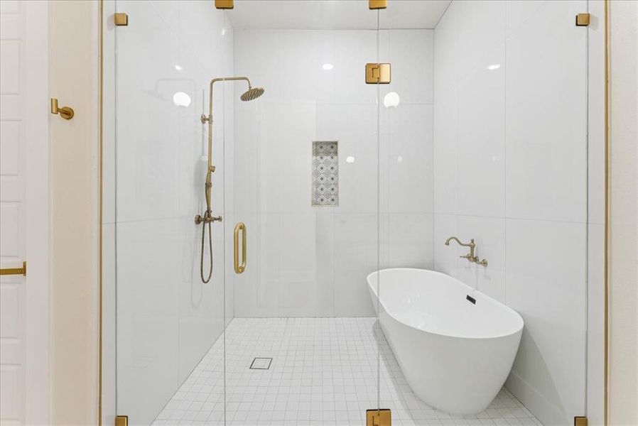 Full bath featuring a shower stall, tile walls, a freestanding tub, and tile patterned floors