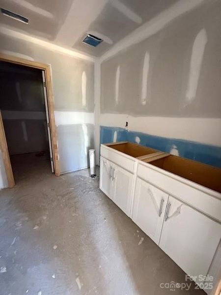 Primary bathroom with dual vanity, walk in tile shower, linen closet and walk in closet.