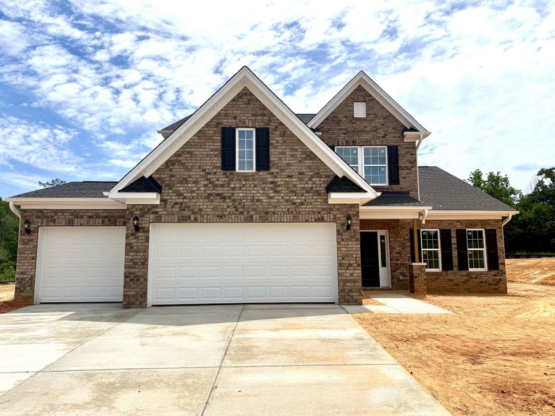 Front exterior of a new home in Brooke Hill, Lewisville, NC, highlighting curb appeal (Image 1). Front exterior of a new home in Brooke Hill, Lewisville, NC, highlighting curb appeal (Image 1).