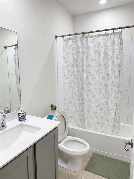 Bathroom featuring a single-sink vanity with gray cabinetry, a white countertop, and a chrome faucet Bathroom featuring a single-sink vanity with gray cabinetry, a white countertop, and a chrome faucet