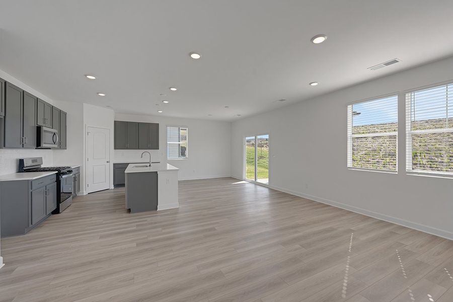 A large kitchen with black cabinets.