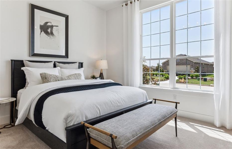 Roomy secondary bedroom with extensive closet storage  *Real home pictured