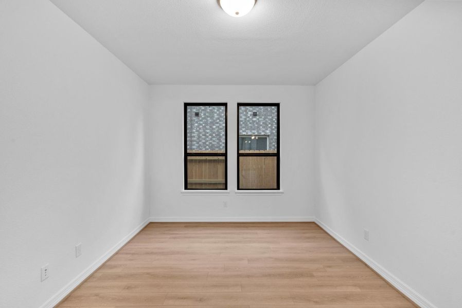 The private study is appointed with French doors, elegant flooring, and abundant natural light.