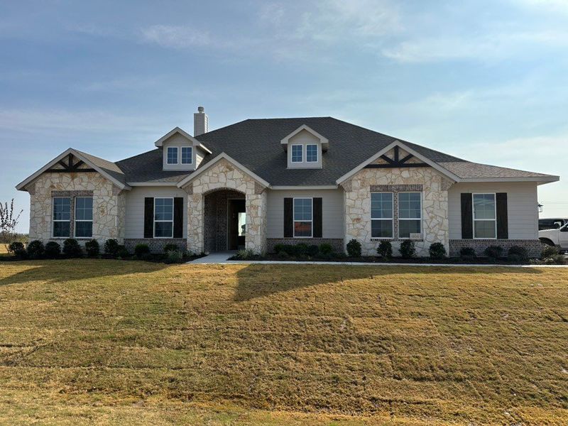 Front exterior of a new home in Eagle Ridge Estates, Weatherford, TX, highlighting curb appeal (Image 1). Front exterior of a new home in Eagle Ridge Estates, Weatherford, TX, highlighting curb appeal (Image 1).