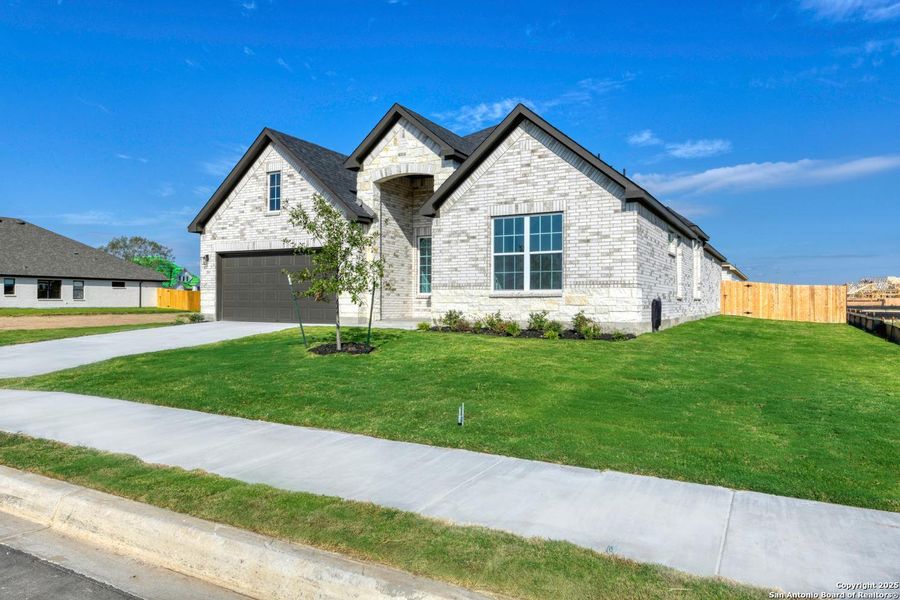 Front exterior of a new home in The Heritage at Saddlebrook Ranch 70's, Schertz, TX, highlighting curb appeal (Image 2). Front exterior of a new home in The Heritage at Saddlebrook Ranch 70's, Schertz, TX, highlighting curb appeal (Image 2).