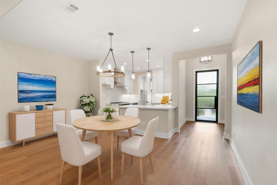 Dining space with a chandelier, visible vents, and light wood-style floors Dining space with a chandelier, visible vents, and light wood-style floors
