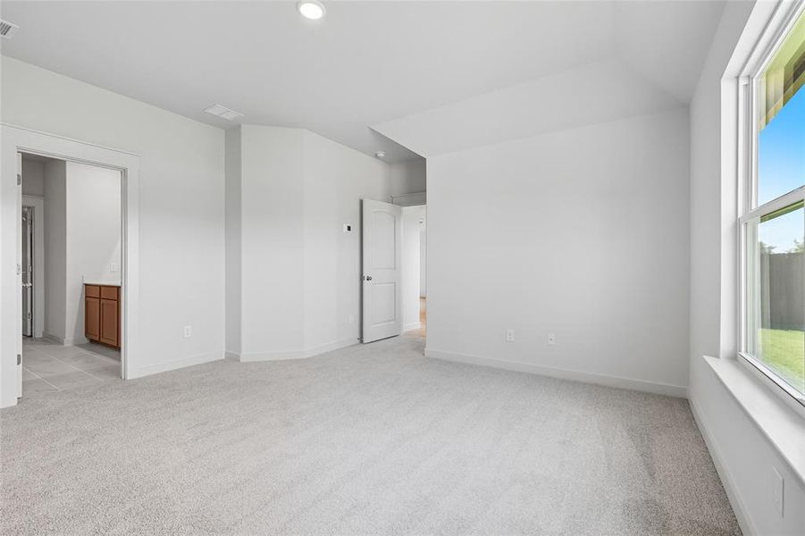 Unfurnished room with light colored carpet and recessed lighting