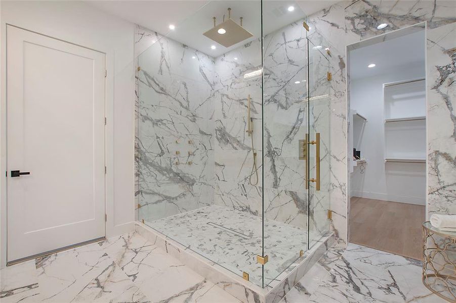 Bathroom with a shower with door and hardwood / wood-style floors