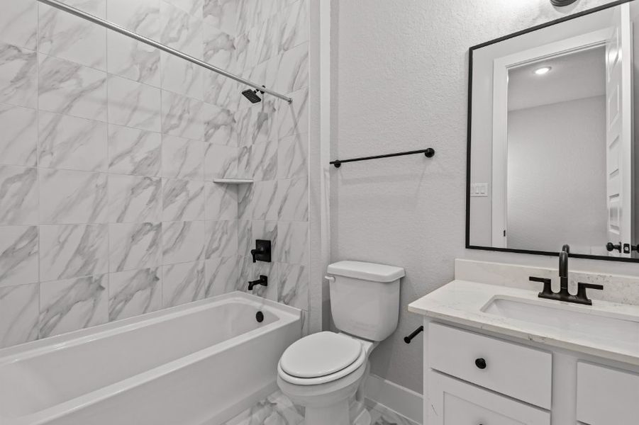 A bathroom with a shower and toilet.