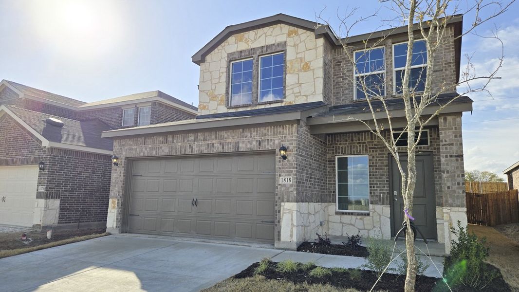 Front exterior of a new home in Creekside Ranch, Blue Ridge, TX, highlighting curb appeal (Image 2).