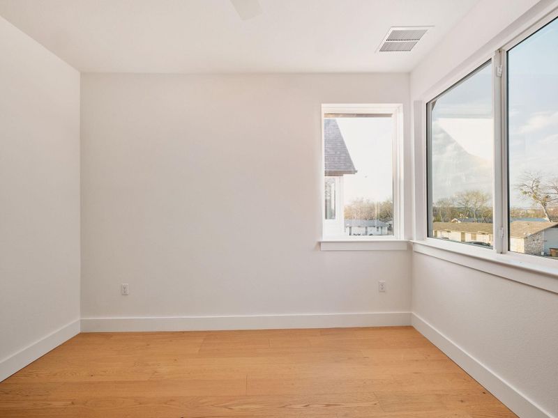 Empty room with light wood-type flooring and a ceiling fan