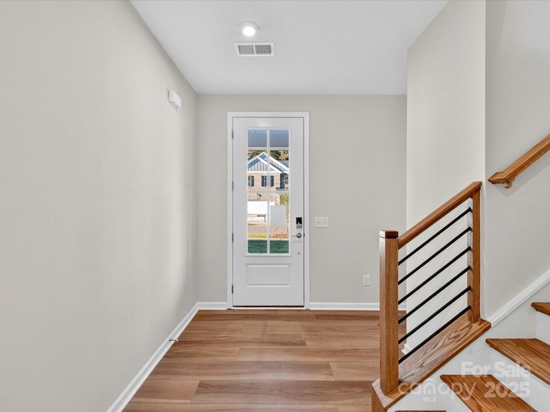 Front Entry with Open Rail Detail Adding Design Interest.