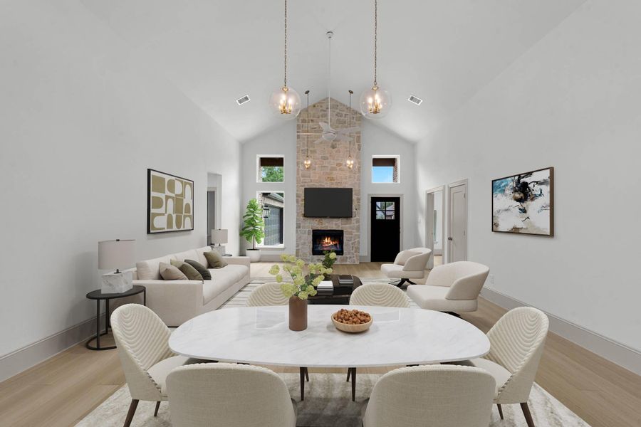 View from the edge of the kitchen to the formal dining area and family room. A floor to ceiling fireplace provides a cozy touch. View from the edge of the kitchen to the formal dining area and family room. A floor to ceiling fireplace provides a cozy touch.