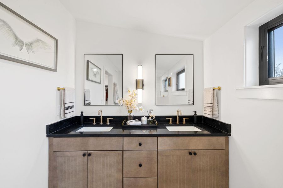 Full bathroom featuring double vanity and a sink