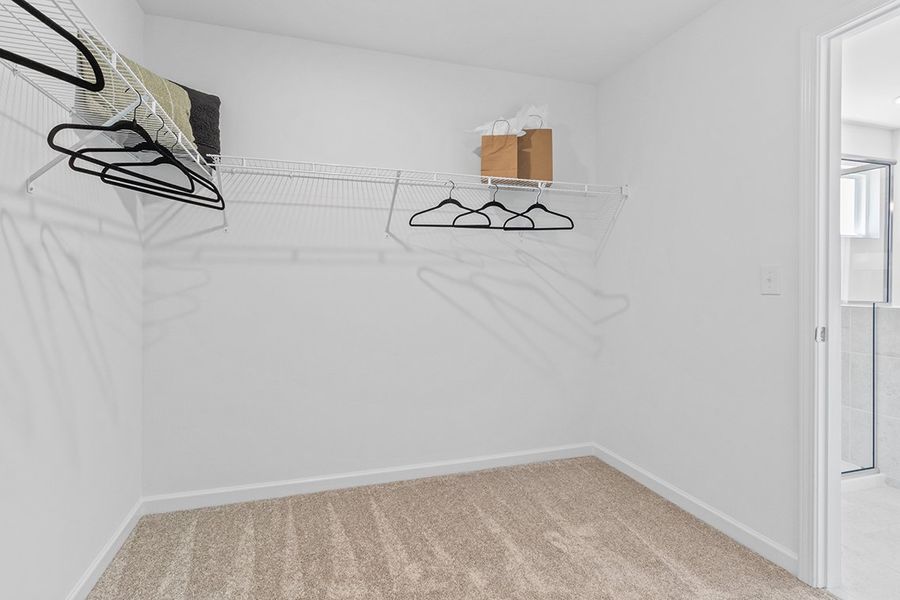 A room with a bed and a chair.