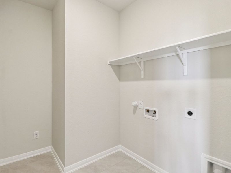 Laundry room in the Callaghan floorplan at a Meritage Homes community.