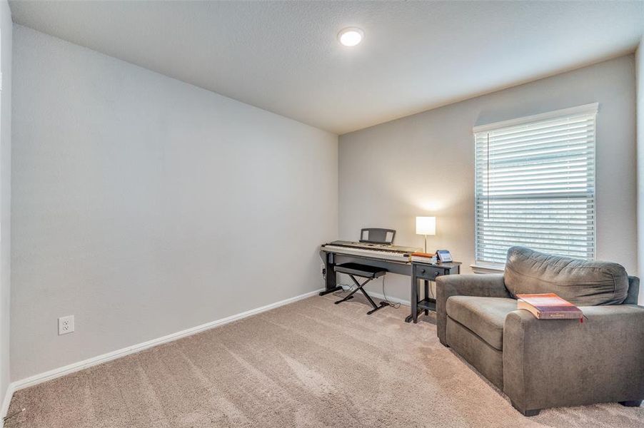 Bedroom with light colored carpet and a textured wall Bedroom with light colored carpet and a textured wall