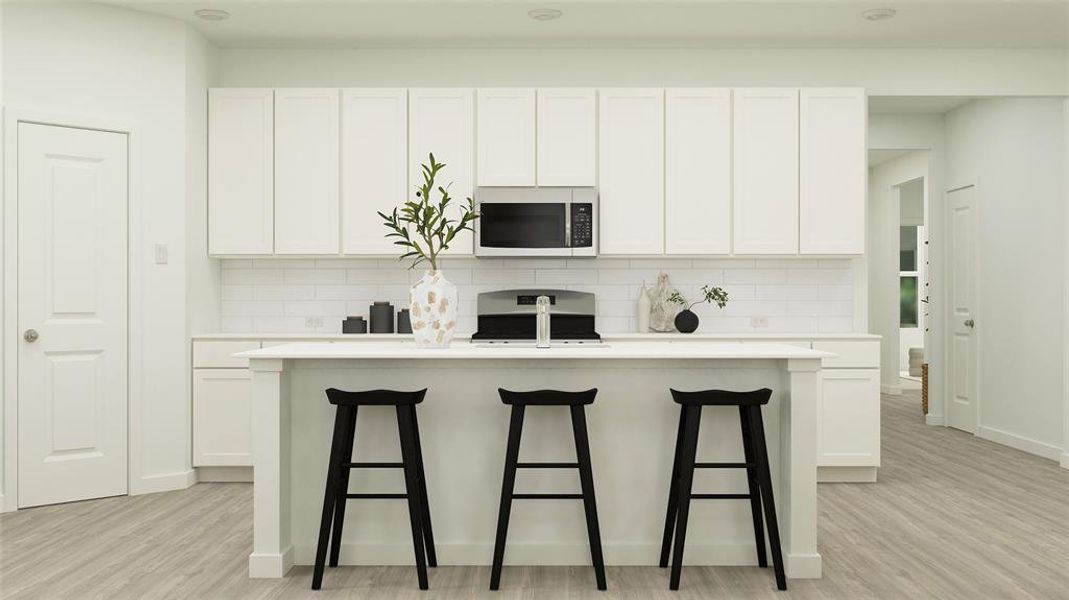 Kitchen featuring stove and white cabinetry