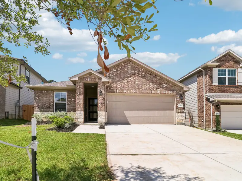 Front exterior of a new home in Pine Lake Cove - Premier Series, Conroe, TX, highlighting curb appeal (Image 2).