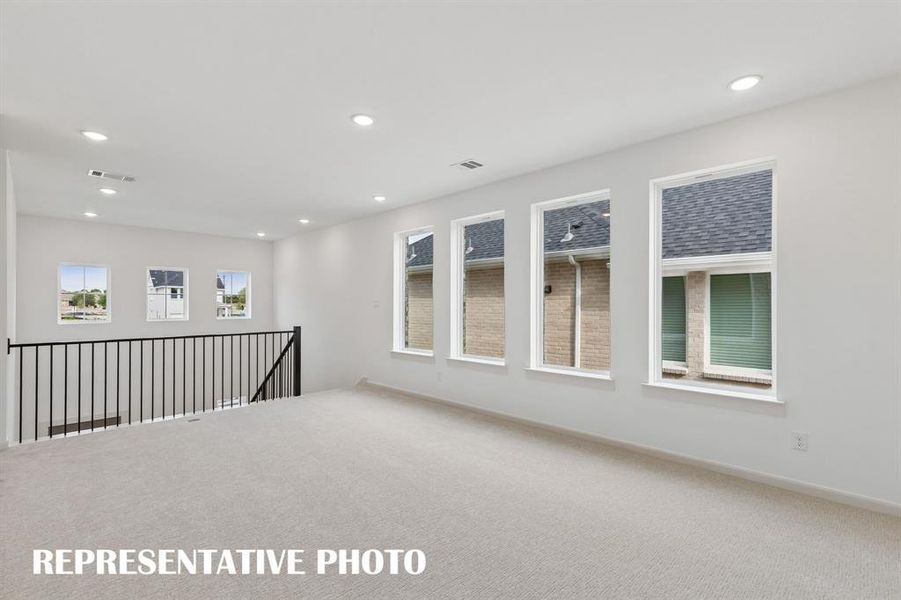 Light, bright and spacious, you'll love hosting family game night or big game day parties in this wonderful game room!  REPRESENTATIVE PHOTO