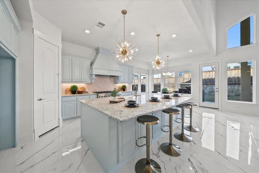 Kitchen featuring pendant lighting, recessed lighting, a spacious island, and quartz countertops Kitchen featuring pendant lighting, recessed lighting, a spacious island, and quartz countertops