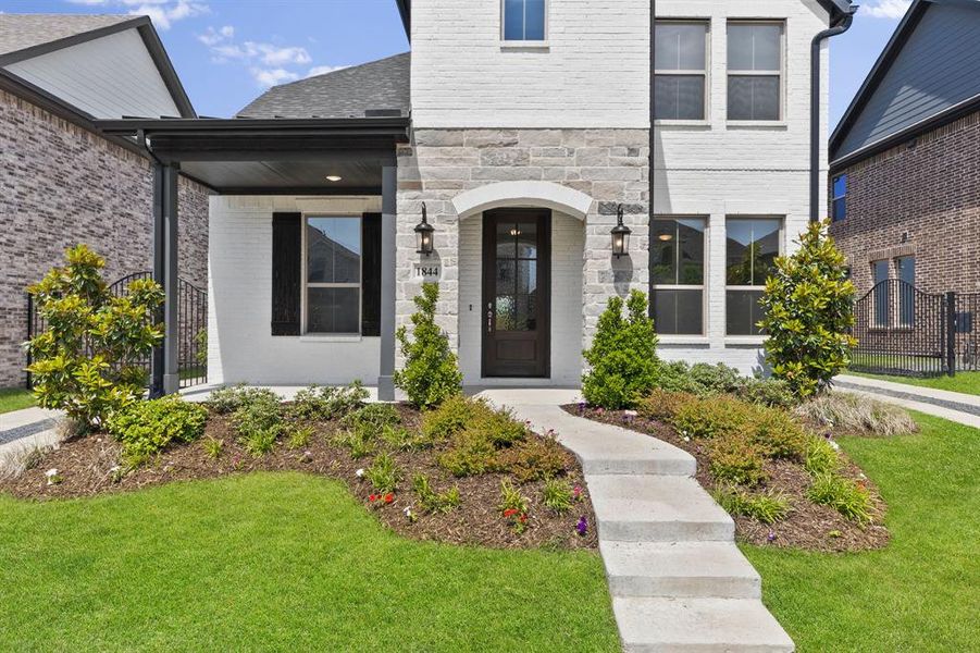 The gorgeous covered front porch offers the ideal space to welcome family and friends into your new home!