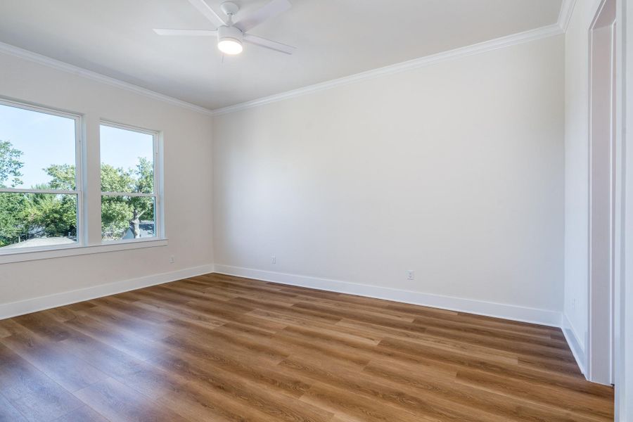 Third bedroom is located upstairs and features warm vinyl flooring and large windows with a ceiling fan. Third bedroom is located upstairs and features warm vinyl flooring and large windows with a ceiling fan.