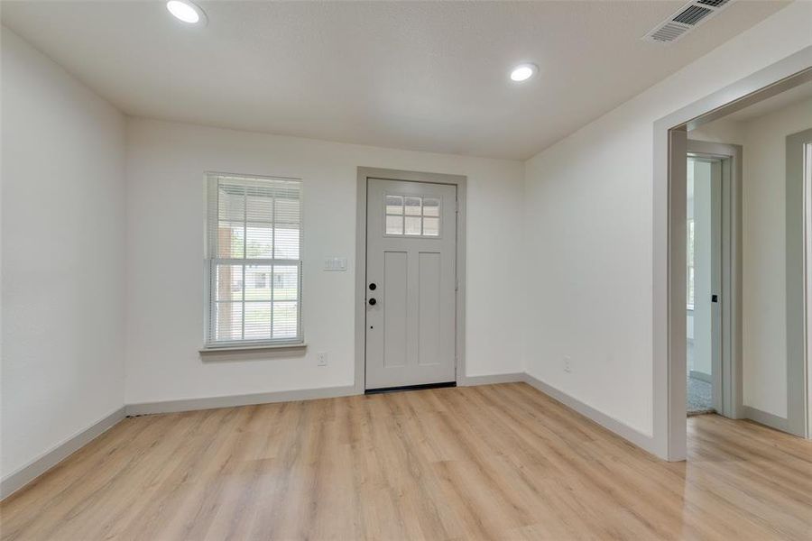 Entrance foyer with light wood-type flooring