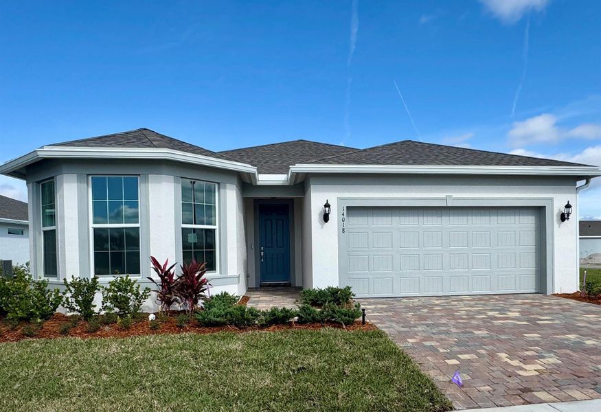 Front exterior of a new home in , Port St. Lucie, FL, highlighting curb appeal (Image 1).