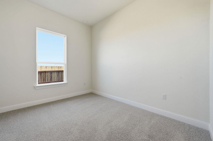 Spare room with baseboards and carpet flooring
